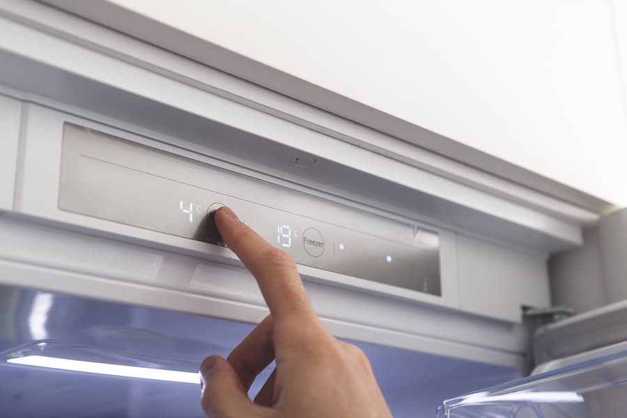 Hand sets temperature of refrigerator